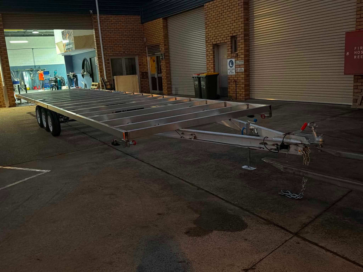 Aluminum Tiny House Trailer 6 meters by 2.4 meter duel Axel aluminum parked outside Coffs Metal Works.