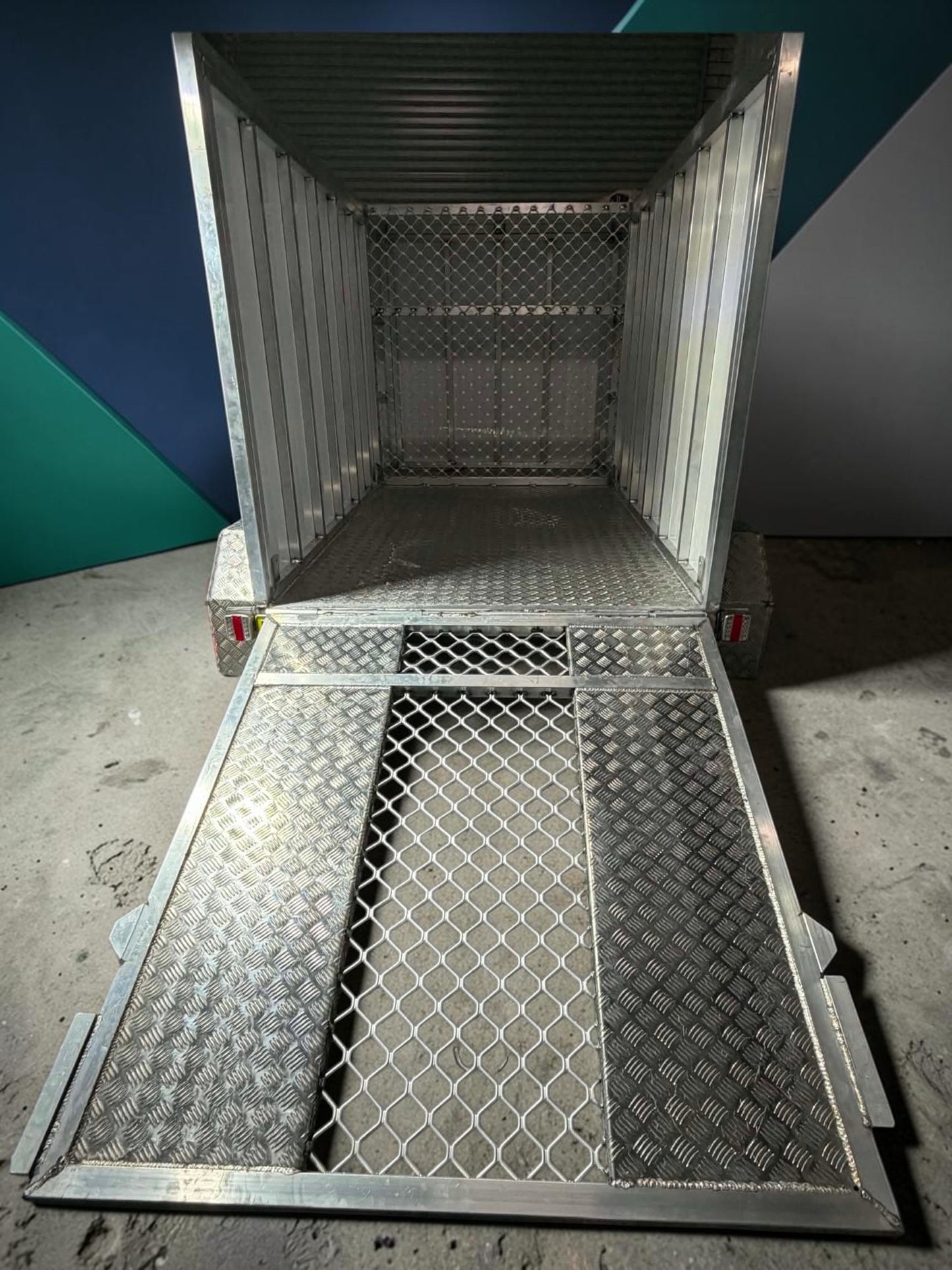 custom aluminum mower trailers with a lightweight, durable design, showcasing the interior and loading ramp.