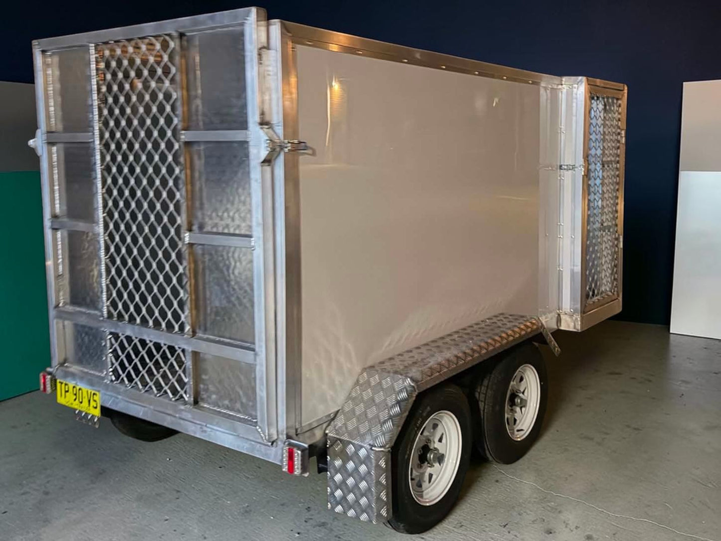 Custom aluminum mower trailers featuring sturdy construction and a robust design suitable for landscaping professionals.