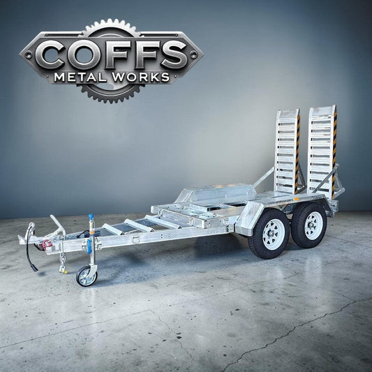 Coffs Metal Works 3000kg plant trailer with dual axles, electric brakes, and aluminium loading ramps. Galvanised steel chassis.