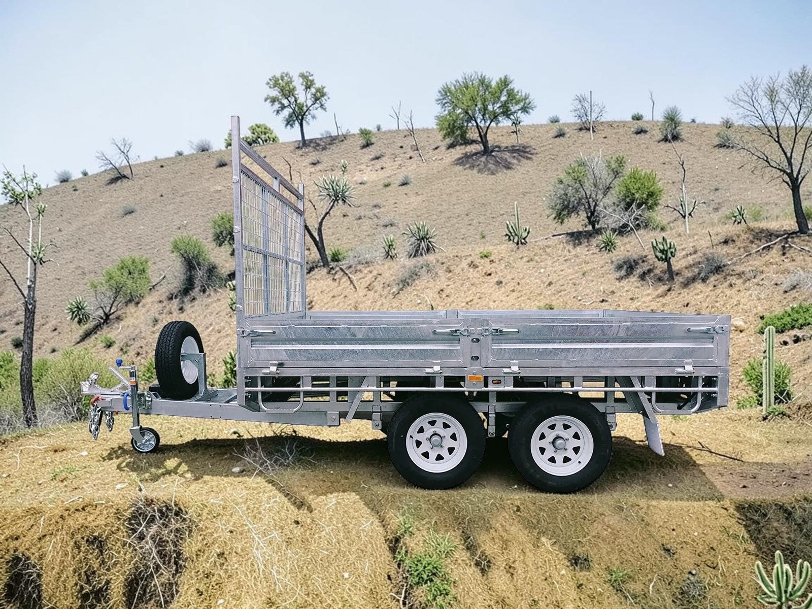 Coffs Metal Works galvanized steel cage trailer with dual axles and spare tire. Ideal for hauling.