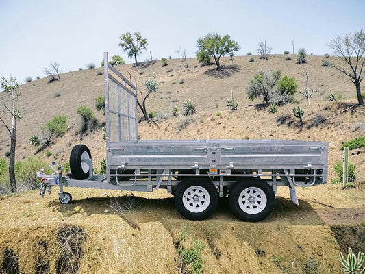 Coffs Metal Works galvanized steel cage trailer with dual axles and spare tire. Ideal for hauling.