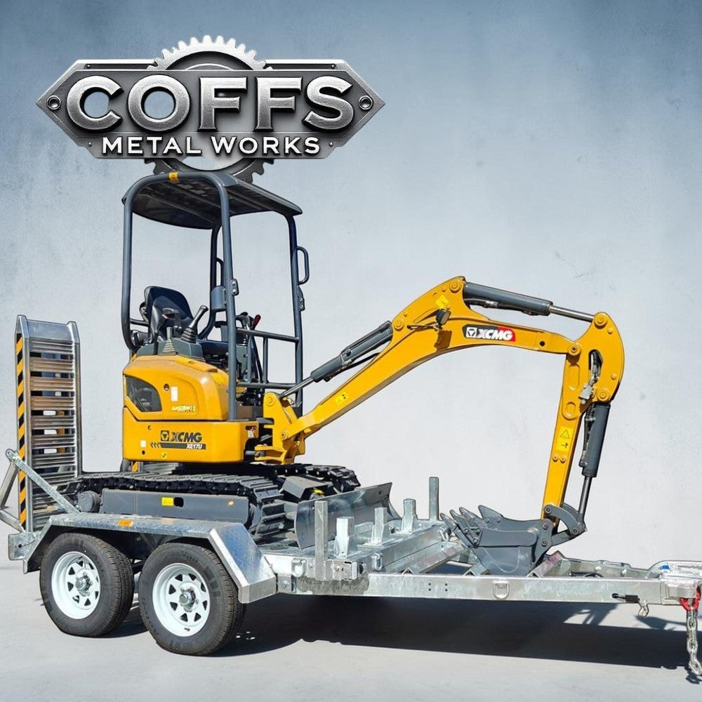 Coffs Metal Works heavy-duty plant trailer with a yellow mini excavator loaded. Galvanised steel trailer with dual axles and aluminum ramps.