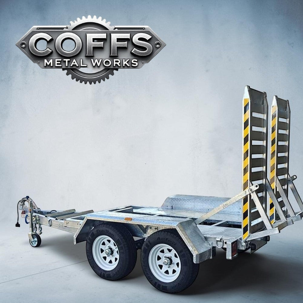 Coffs Metal Works heavy-duty plant trailer with dual axles, aluminium ramps, and galvanised steel chassis.