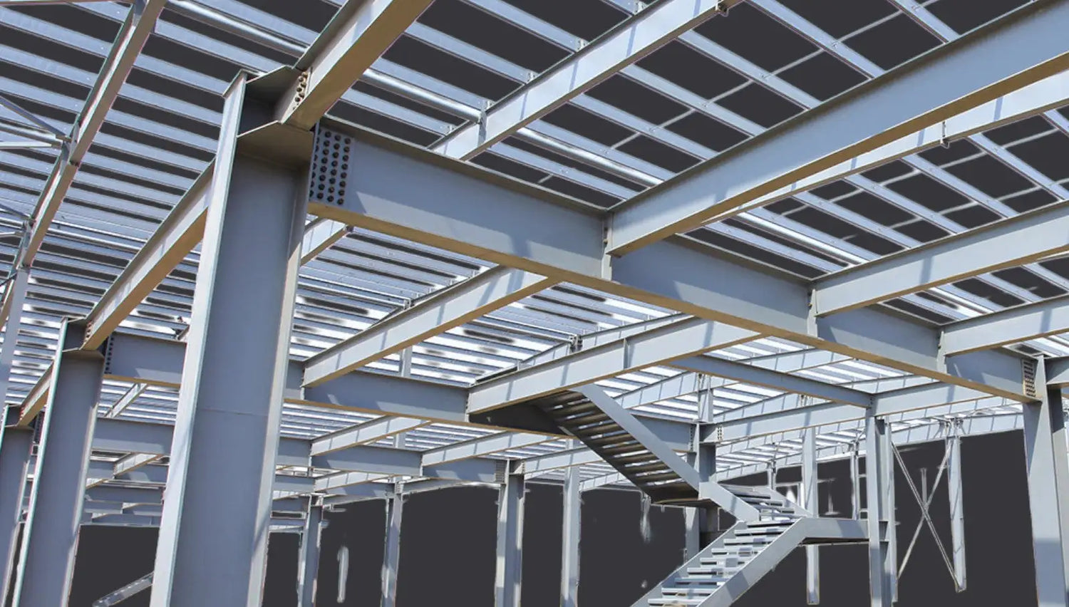 Gray steel i-beam framework with intersecting beams and a staircase.