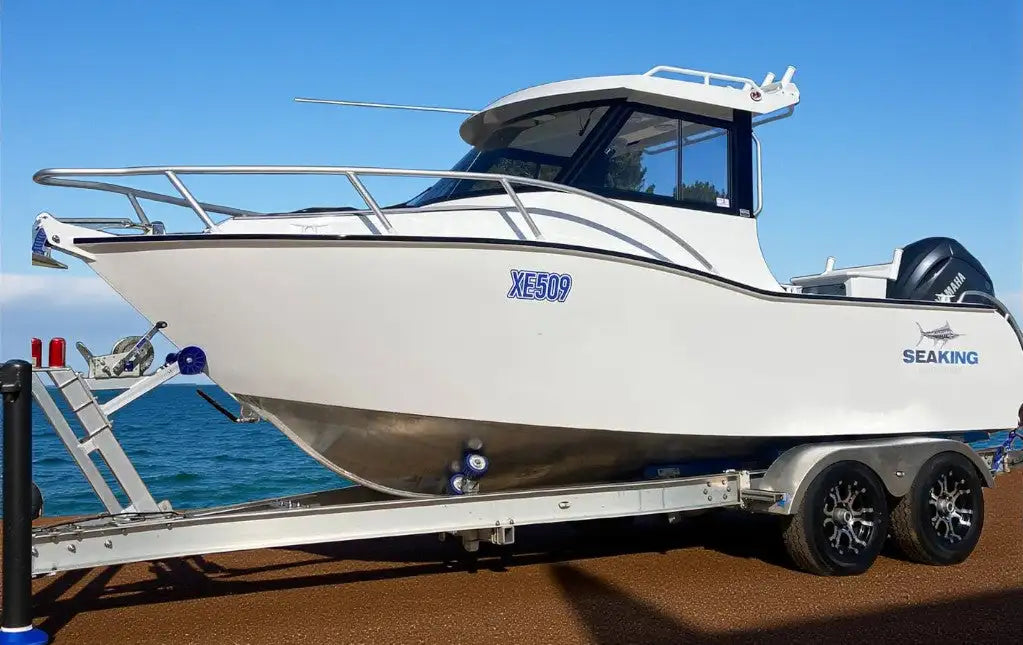White seaking boat with a sleek, modern design and metallic silver hull details.