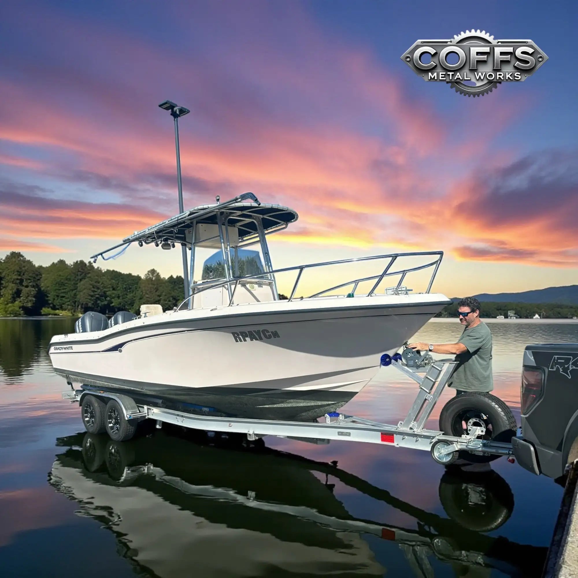White and gray fiberglass motorboat with chrome railings and a canopy, branded ’boston whaler’ on the side.